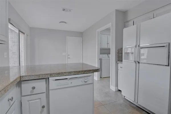 a kitchen with a refrigerator and cabinets