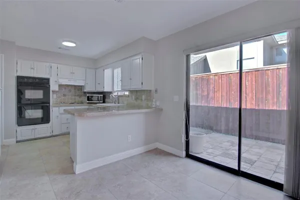 a kitchen with granite countertop a stove a sink and a granite counter top