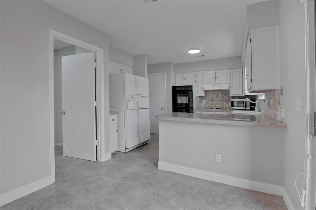 14822 Sopras Circle Addison, TX 75001 - Photo 6 of 33 a kitchen with stainless steel appliances granite countertop a refrigerator a stove and a sink