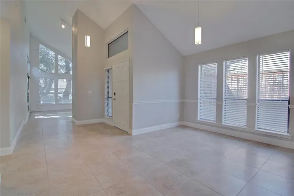 an empty room with windows and entrance