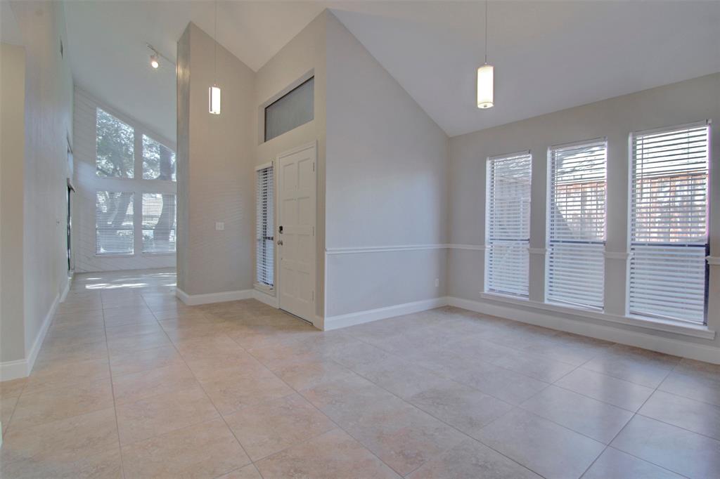 14822 Sopras Circle Addison, TX 75001 - Photo 9 of 33 an empty room with windows and entrance