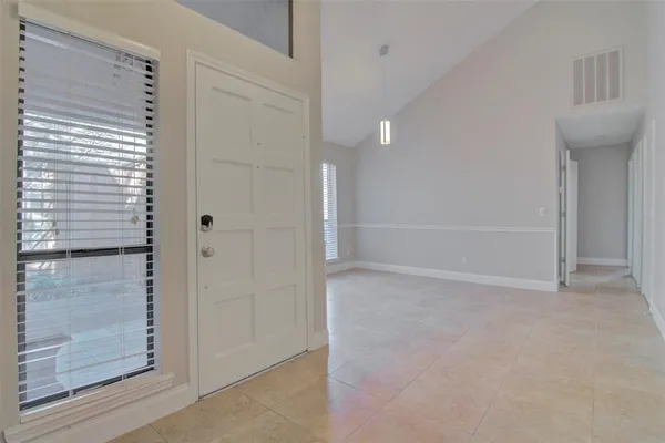 a view of an empty room with windows