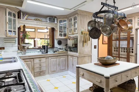 a kitchen with a sink cabinets and window