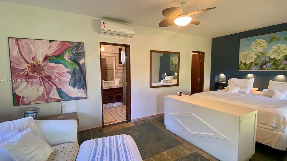 Praia Do Flamengo Saco Da Ribeira undefined, SP 0 - Photo 16 of 33 a bedroom with a bed and a chandelier