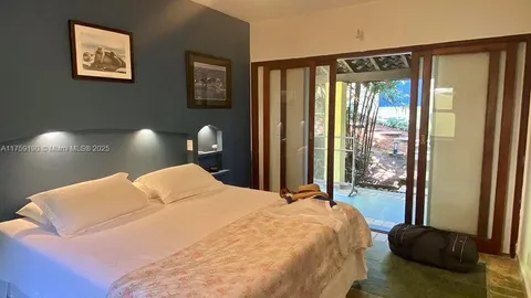 a bedroom with a large bed and a large window