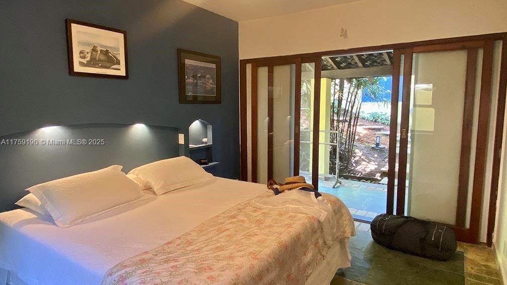 Praia Do Flamengo Saco Da Ribeira undefined, SP 0 - Photo 18 of 33 a bedroom with a large bed and a large window