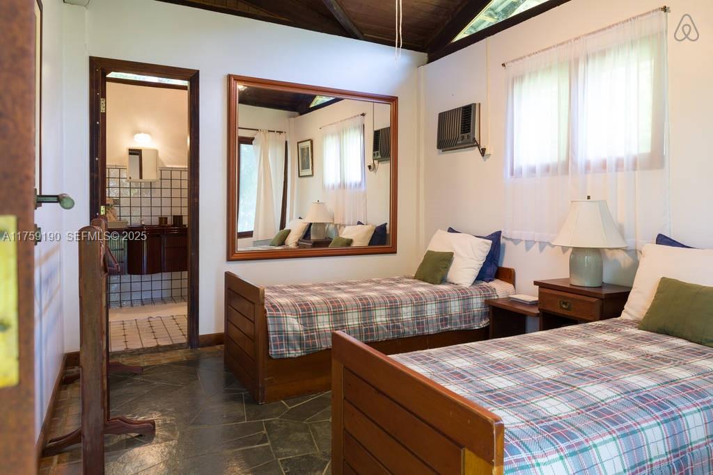 Praia Do Flamengo Saco Da Ribeira undefined, SP 0 - Photo 19 of 33 a large bedroom with two beds and a large window