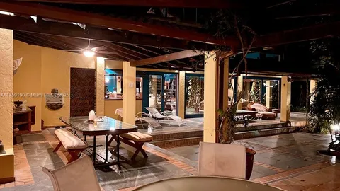 a view of a swimming pool with outdoor seating