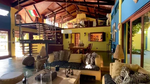 a living room with furniture and a floor to ceiling window