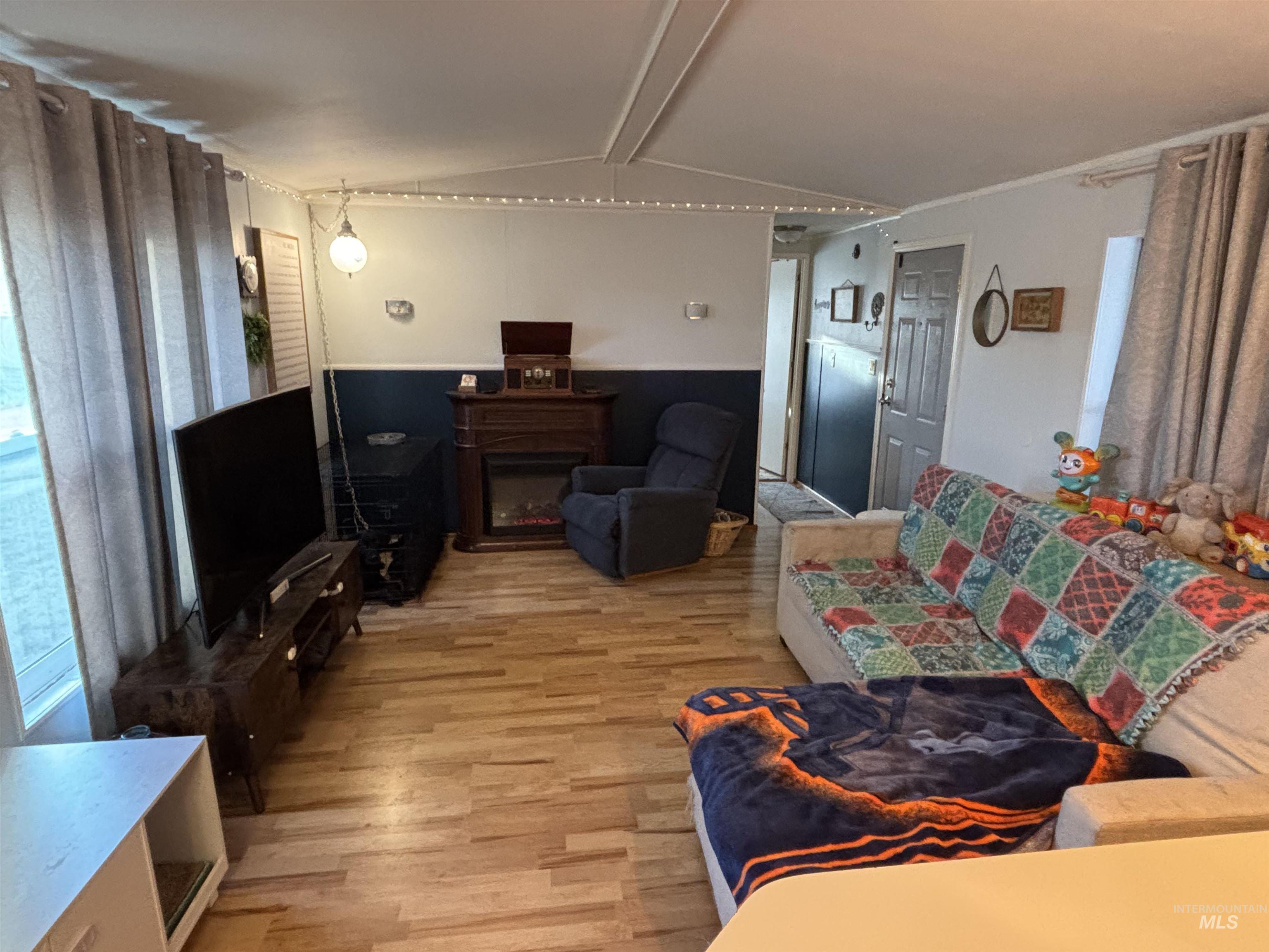 609 North Almon Street, Unit 3024 Moscow, ID 83843 - Photo 4 of 17 Living area with a glass covered fireplace and light wood-style flooring