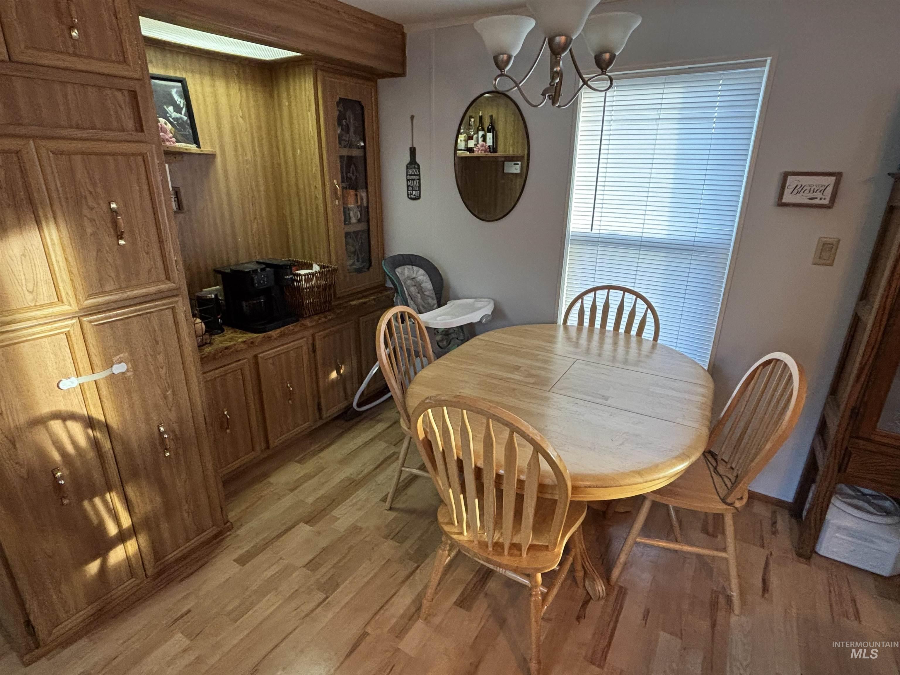 609 North Almon Street, Unit 3024 Moscow, ID 83843 - Photo 7 of 17 Dining room with a chandelier, light wood-style floors, and wood walls