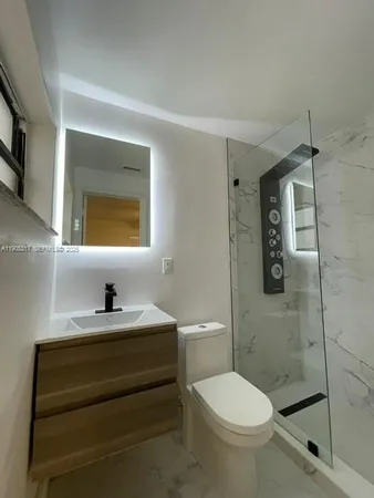 a bathroom with a sink toilet and shower