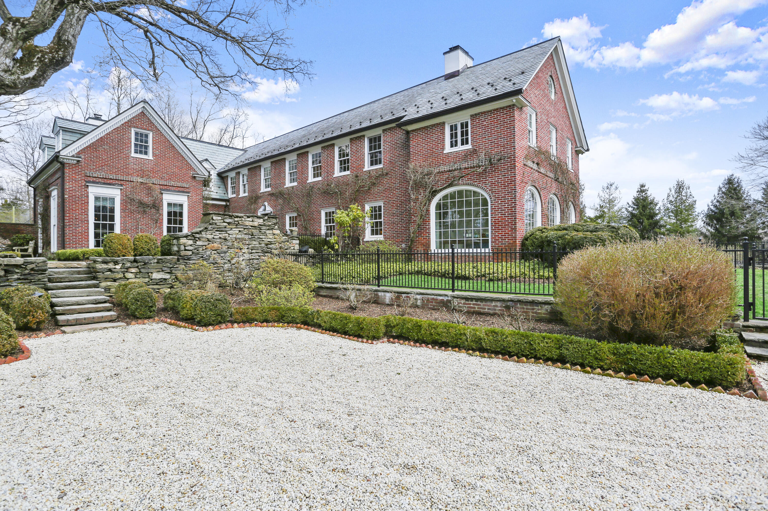 313 Stanwich Road Greenwich, CT 06830 - Photo 3 of 23 a front view of a house with a yard and garage