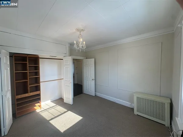 a view of a room with wooden floor and stairs
