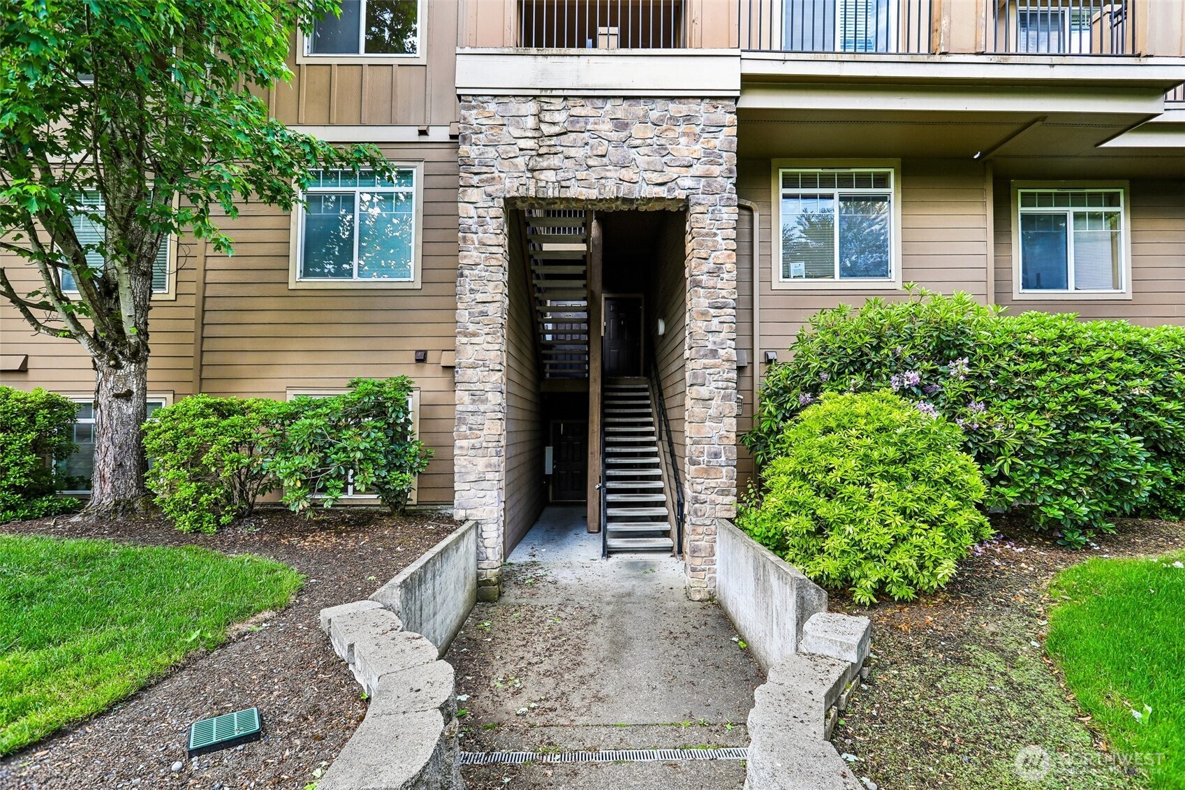 18930 Bothell Everett Highway, Unit E301 Bothell, WA 98012 - Photo 3 of 28 a front view of a house with garden