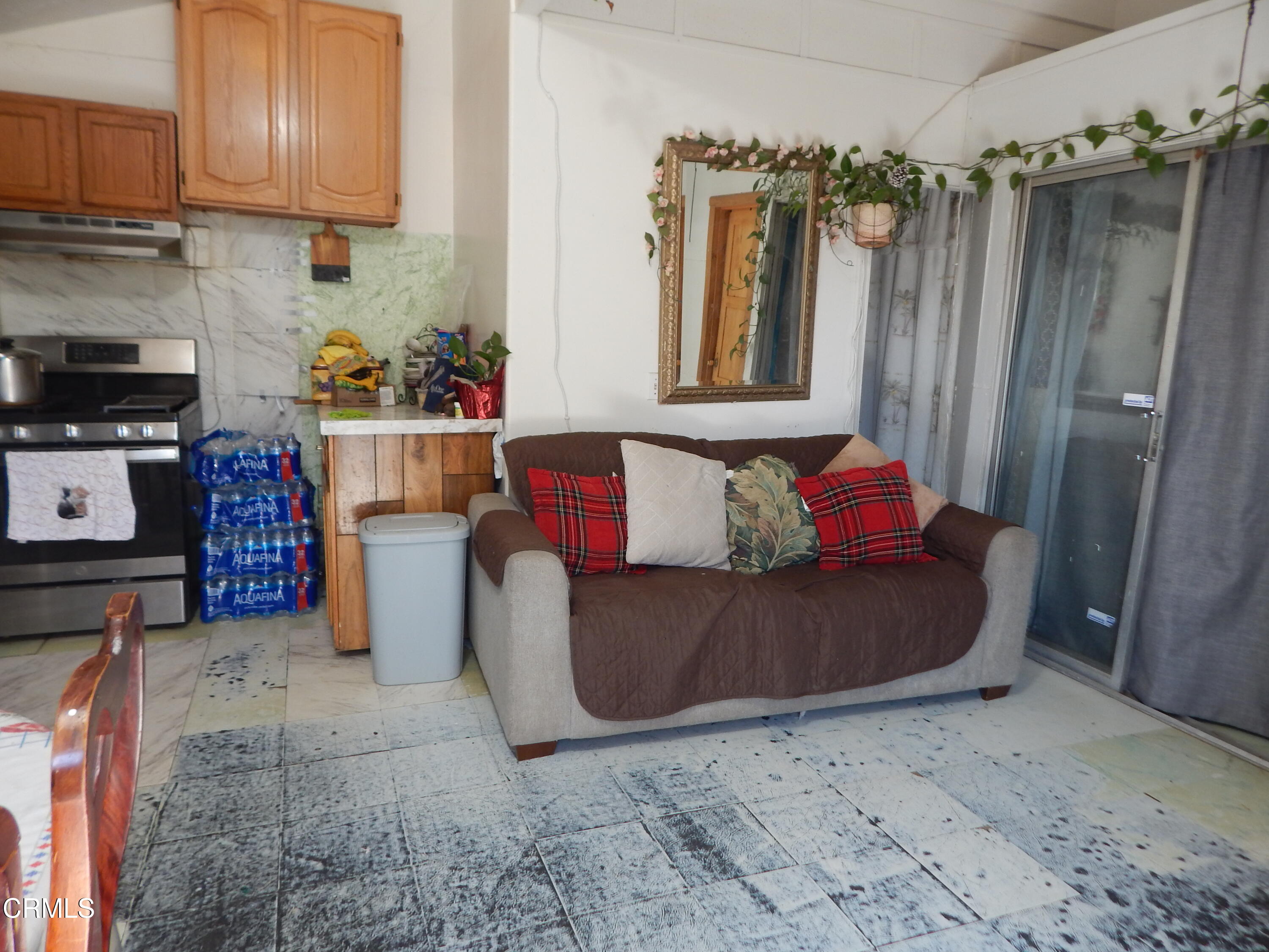 2746 Friedrich Road Oxnard, CA 93036 - Photo 19 of 36 a living room with furniture and a refrigerator