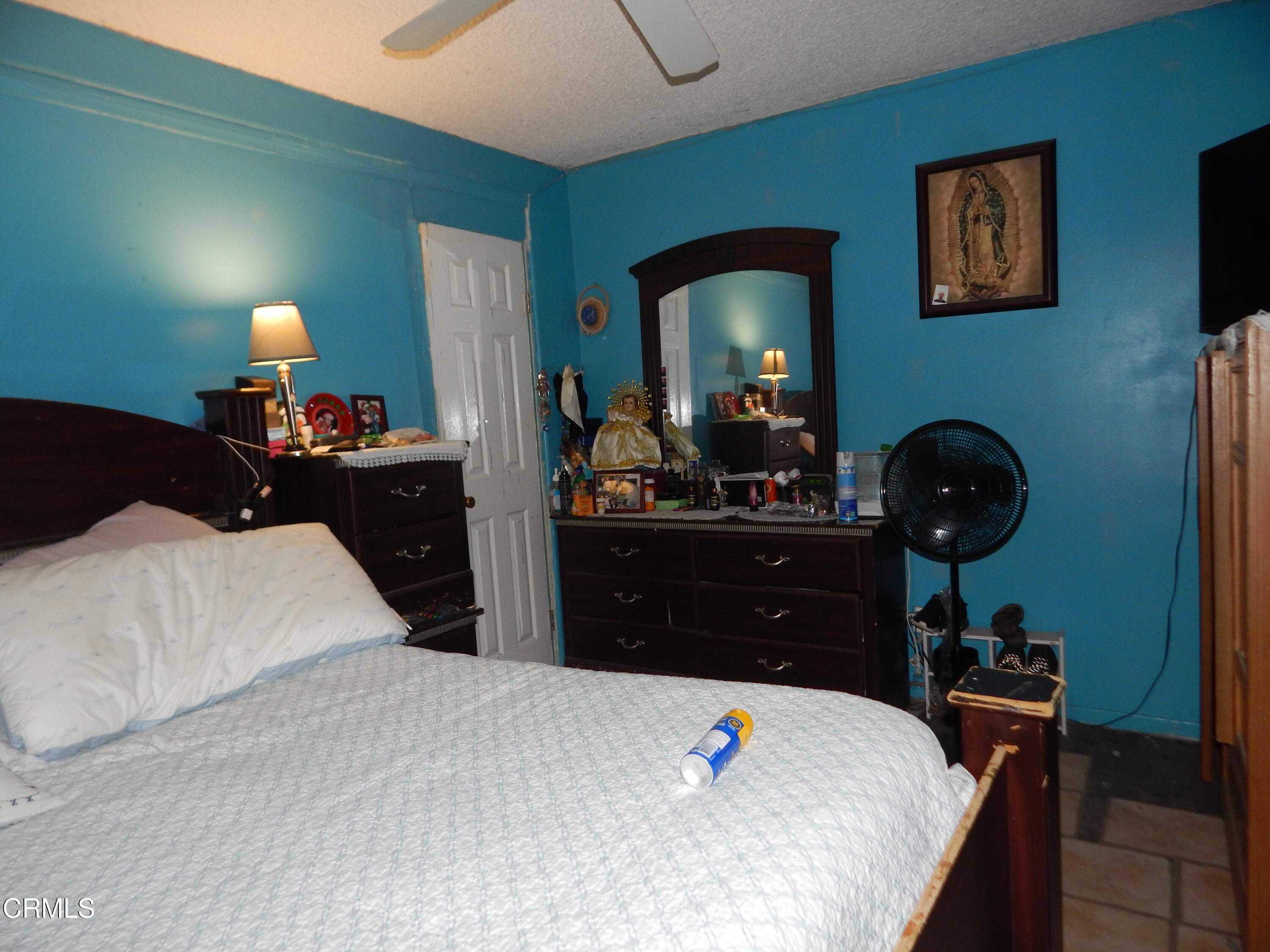 2746 Friedrich Road Oxnard, CA 93036 - Photo 20 of 36 a bedroom with a bed and a chandelier