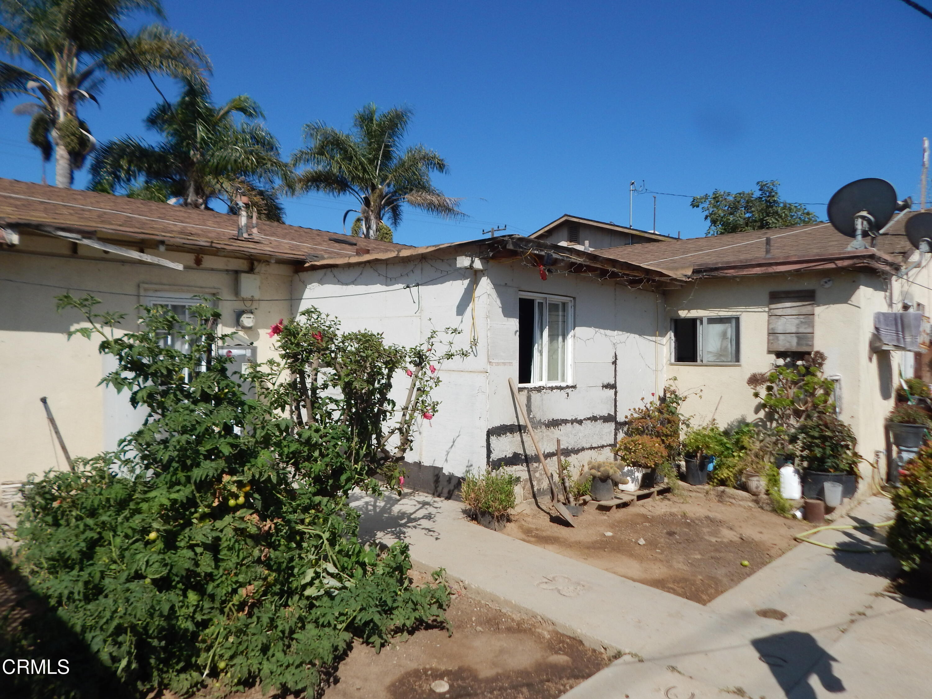 2746 Friedrich Road Oxnard, CA 93036 - Photo 24 of 36 a front view of a house with a yard and garage