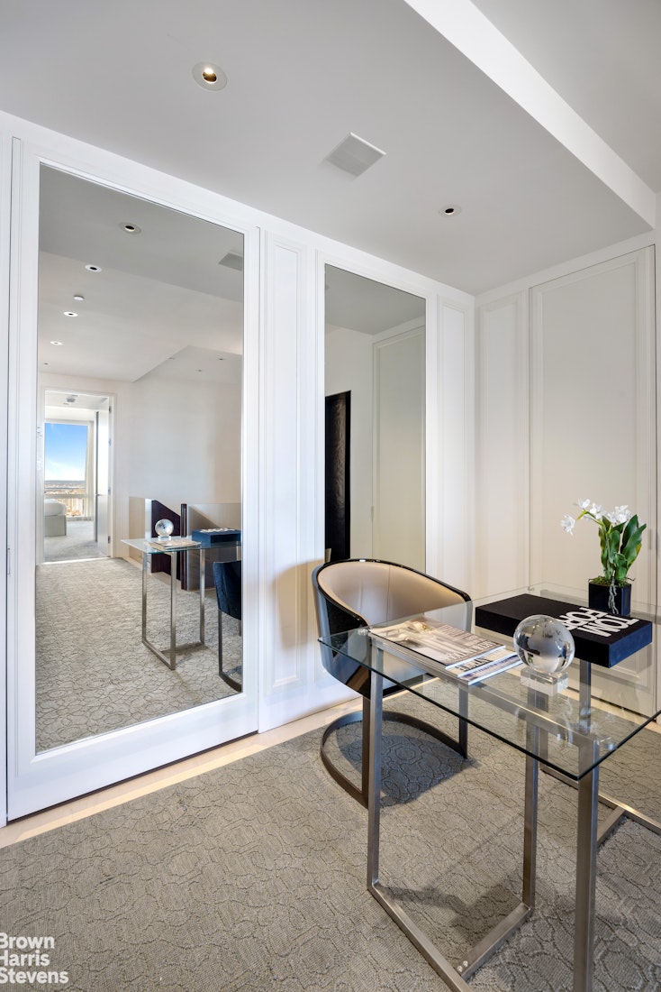 25 Columbus Circle, Unit 7273B Manhattan, NY 10019 - Photo 10 of 15 a workspace with furniture and wooden floor