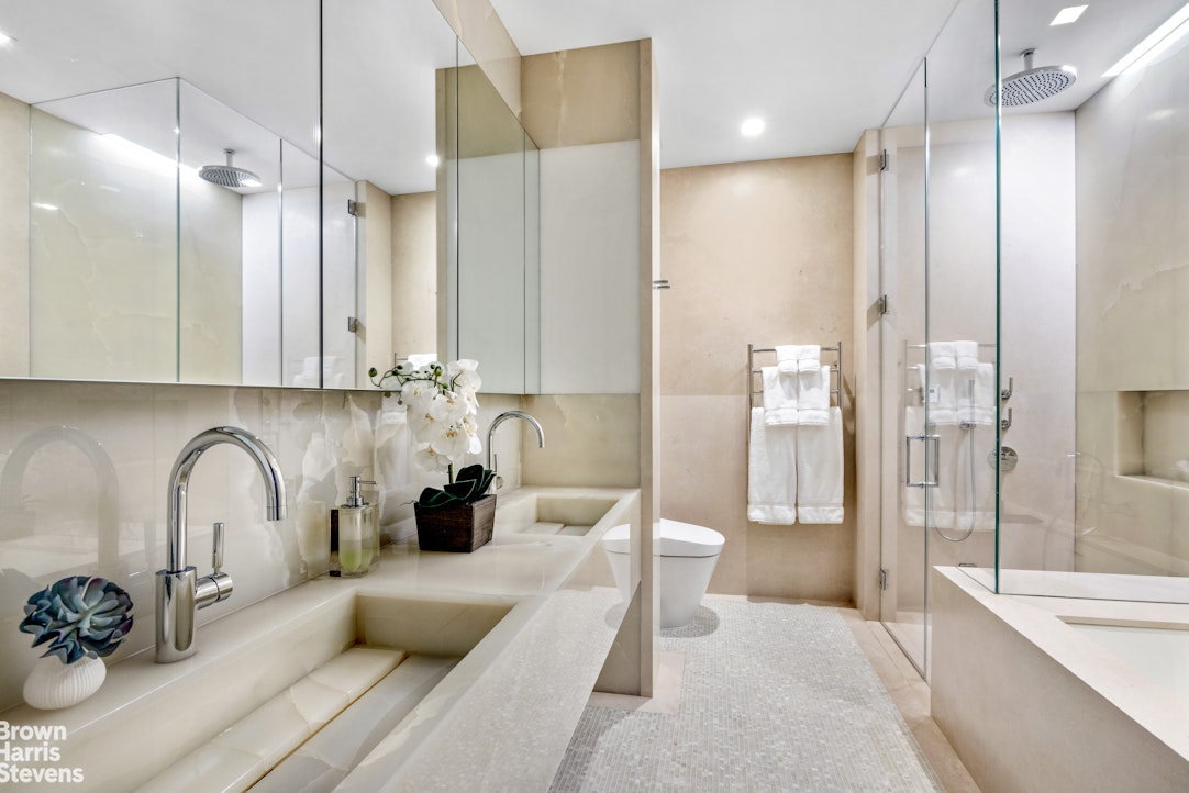 25 Columbus Circle, Unit 7273B Manhattan, NY 10019 - Photo 6 of 15 a bathroom with double vanity and a bathtub