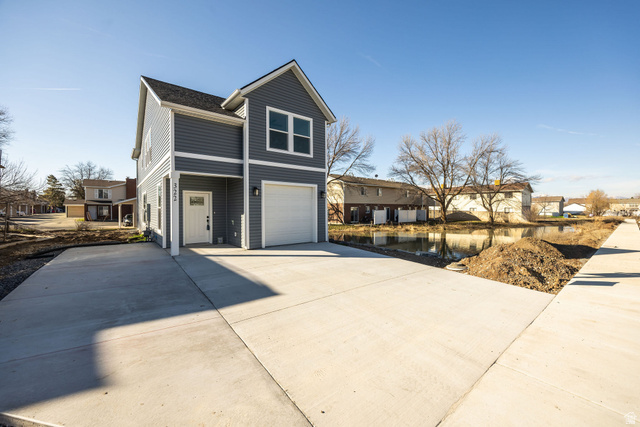 322 West 690 North Logan, UT 84321 - Photo 2 of 25 View of front of house featuring concrete driveway, an attached garage, and a residential view