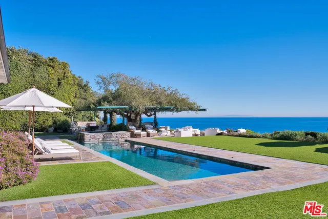 a view of a backyard with swimming pool