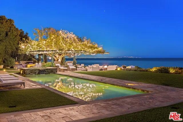 a view of a patio with couches table and chairs and potted plants