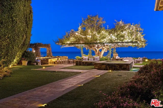 a view of a backyard with sitting area