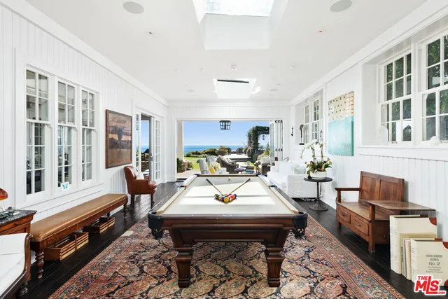 a living room with furniture fireplace and wooden floor