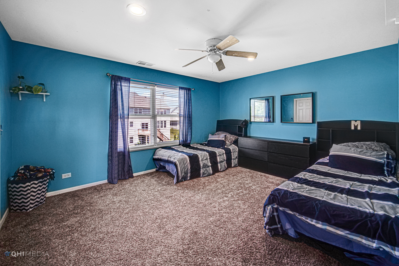318 Monument Road Elgin, IL 60124 - Photo 19 of 31 a bedroom with two beds and a chandelier