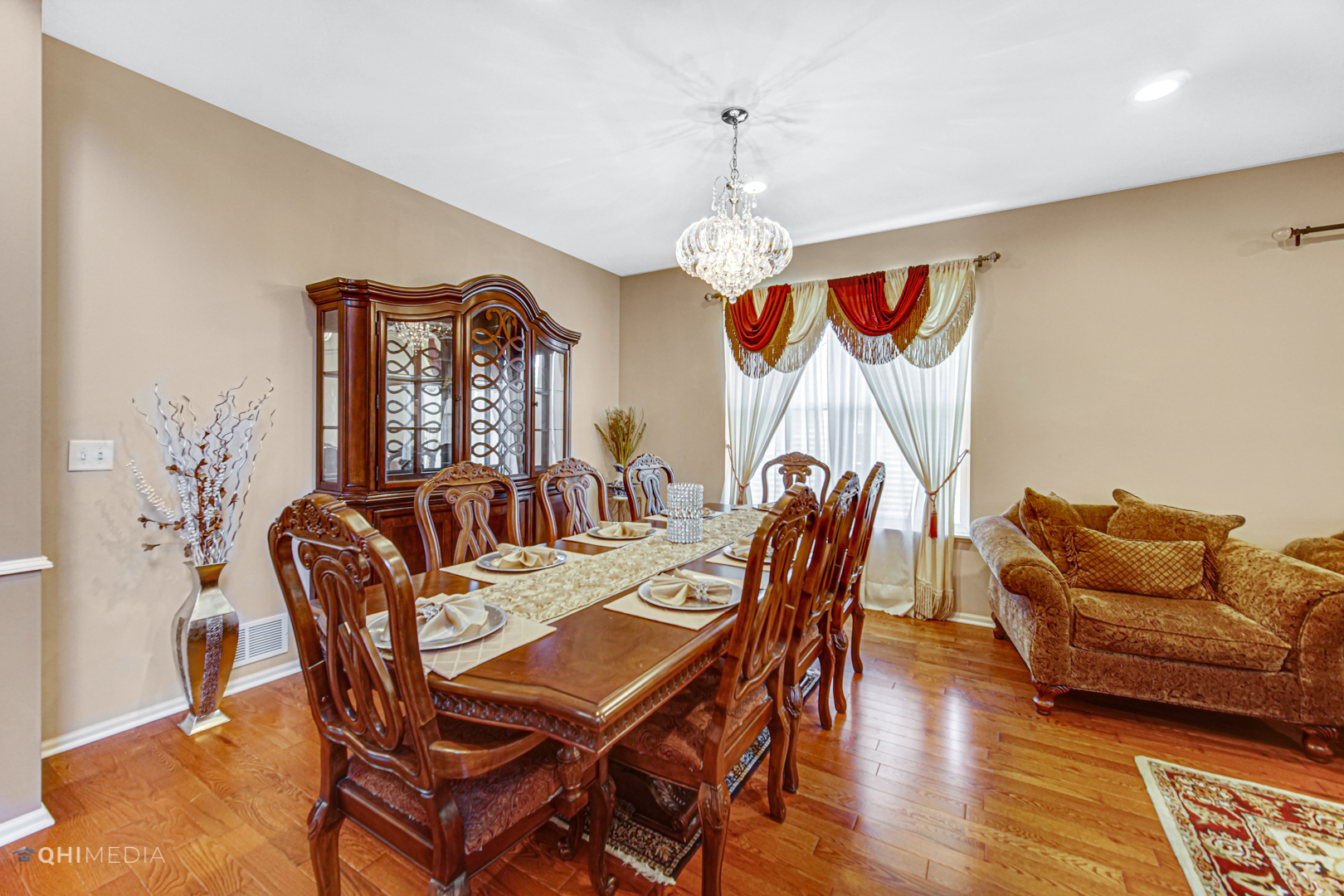 318 Monument Road Elgin, IL 60124 - Photo 6 of 31 a dining room with furniture a chandelier and wooden floor