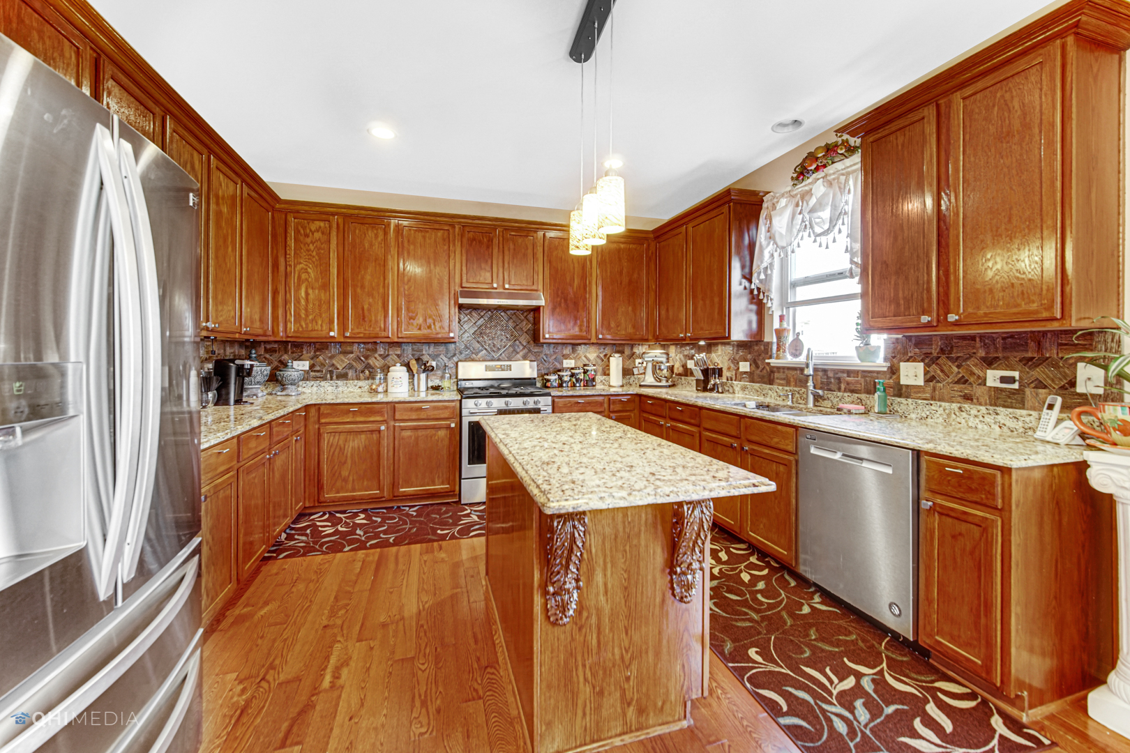 318 Monument Road Elgin, IL 60124 - Photo 10 of 31 a kitchen with stainless steel appliances granite countertop a stove a sink dishwasher and a refrigerator