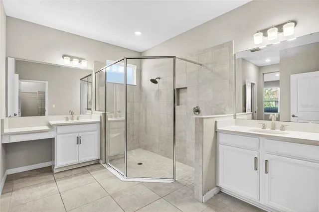 a bathroom with a shower sink and mirror