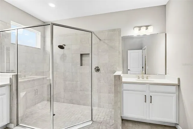 a bathroom with a shower sink and mirror