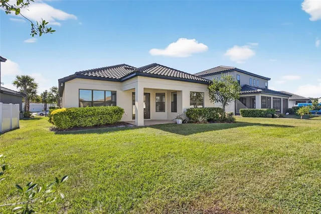 a front view of a house with swimming pool having outdoor seating