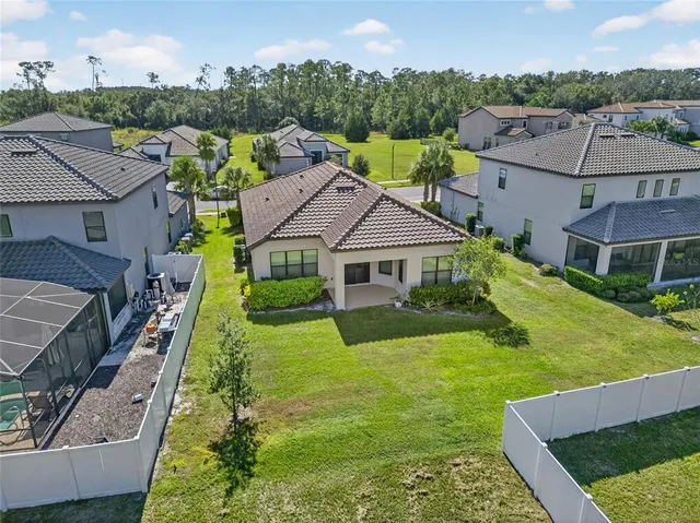 aerial view of a house with yard and green space