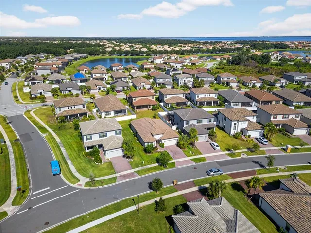 an aerial view of residential houses with outdoor space and swimming pool