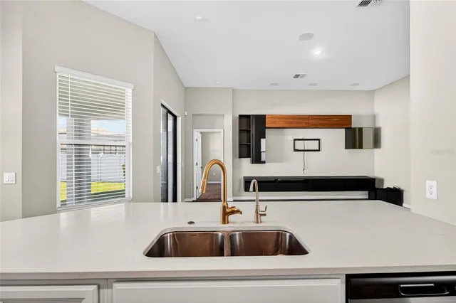 a kitchen with a sink and a large window