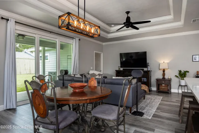 a living room with furniture or chandelier and a wooden floor