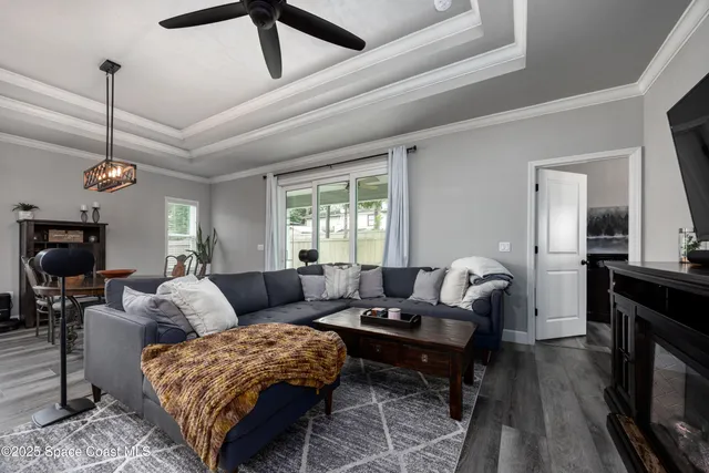 a living room with furniture a flat screen tv and a fireplace