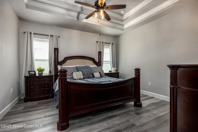 a bedroom with a bed and a chandelier