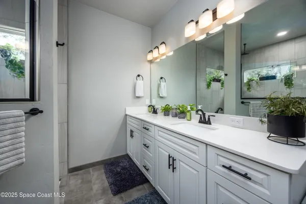 a room with lots of tables a large window and outdoor space