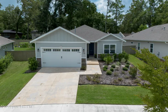 an aerial view of a house with yard swimming pool and outdoor seating