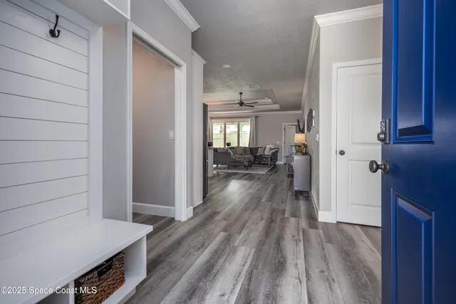 a view of a hallway view with wooden floor and staircase