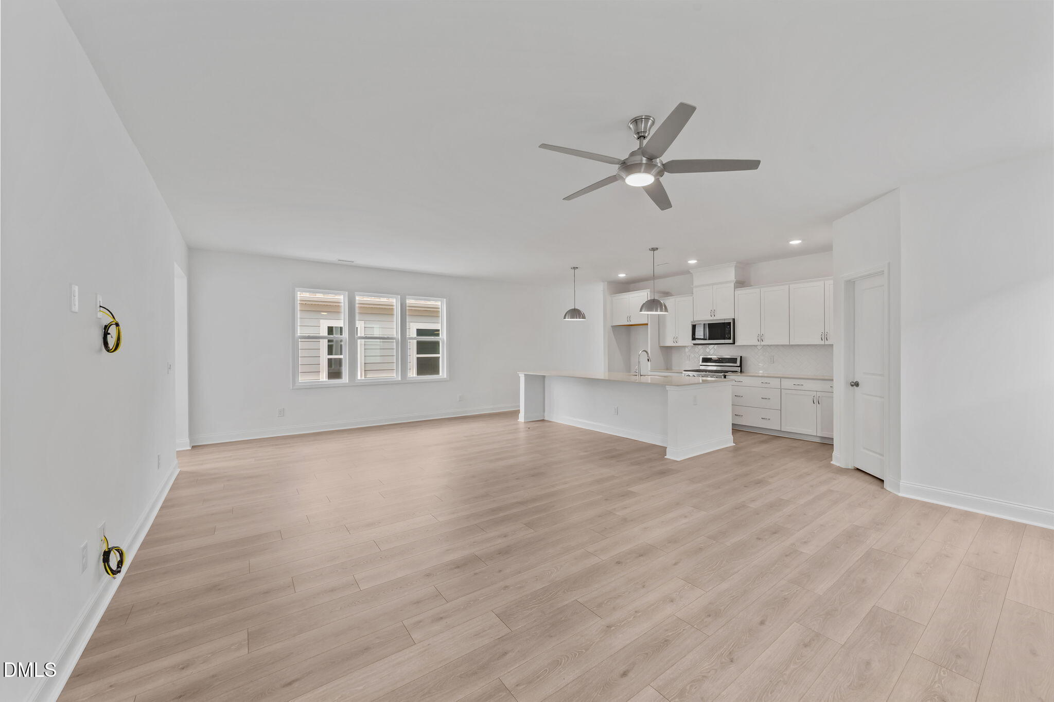 77 Watauga Way Clayton, NC 27520 - Photo 5 of 10 a view of an empty room with kitchen appliances and a window