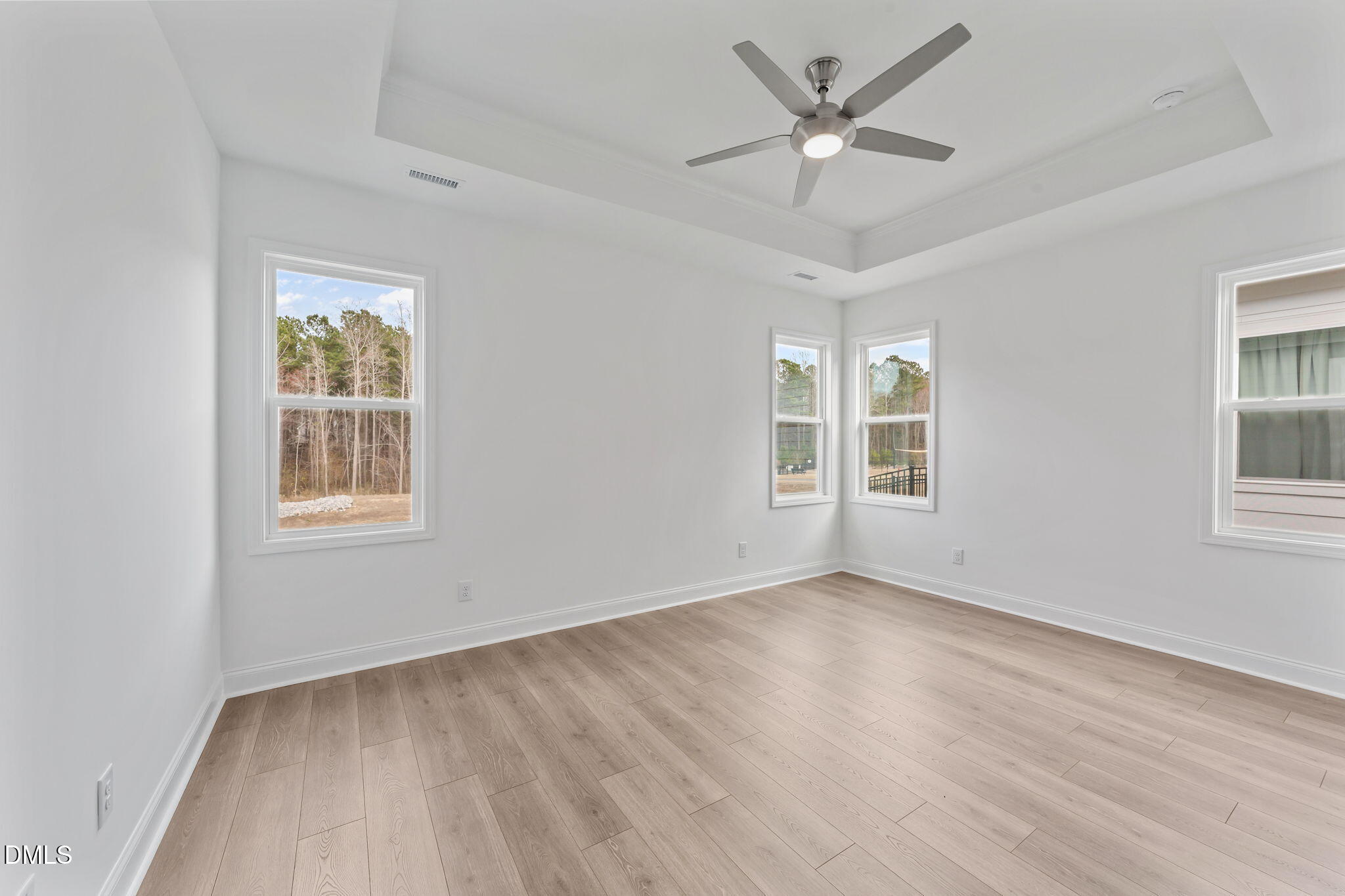 77 Watauga Way Clayton, NC 27520 - Photo 8 of 10 a view of an empty room with a window and wooden floor