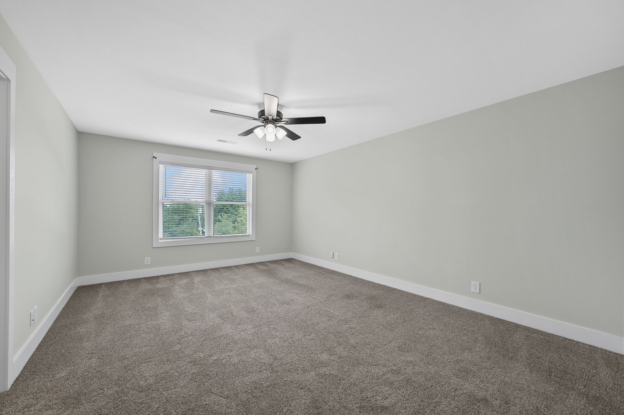 2509 Ashland City Road Clarksville, TN 37043 - Photo 18 of 32 an empty room with windows and fan