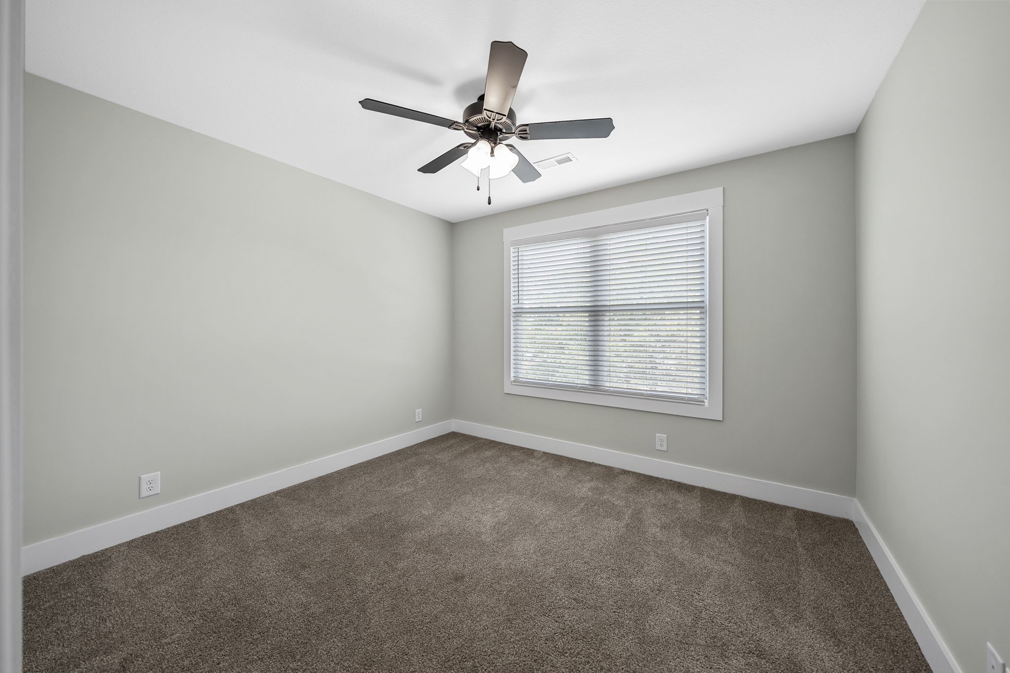 2509 Ashland City Road Clarksville, TN 37043 - Photo 23 of 32 an empty room with a window and a fan