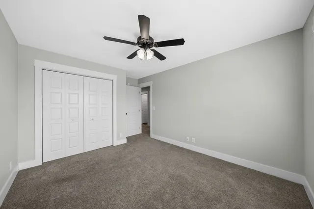 a view of a livingroom with a ceiling fan and window