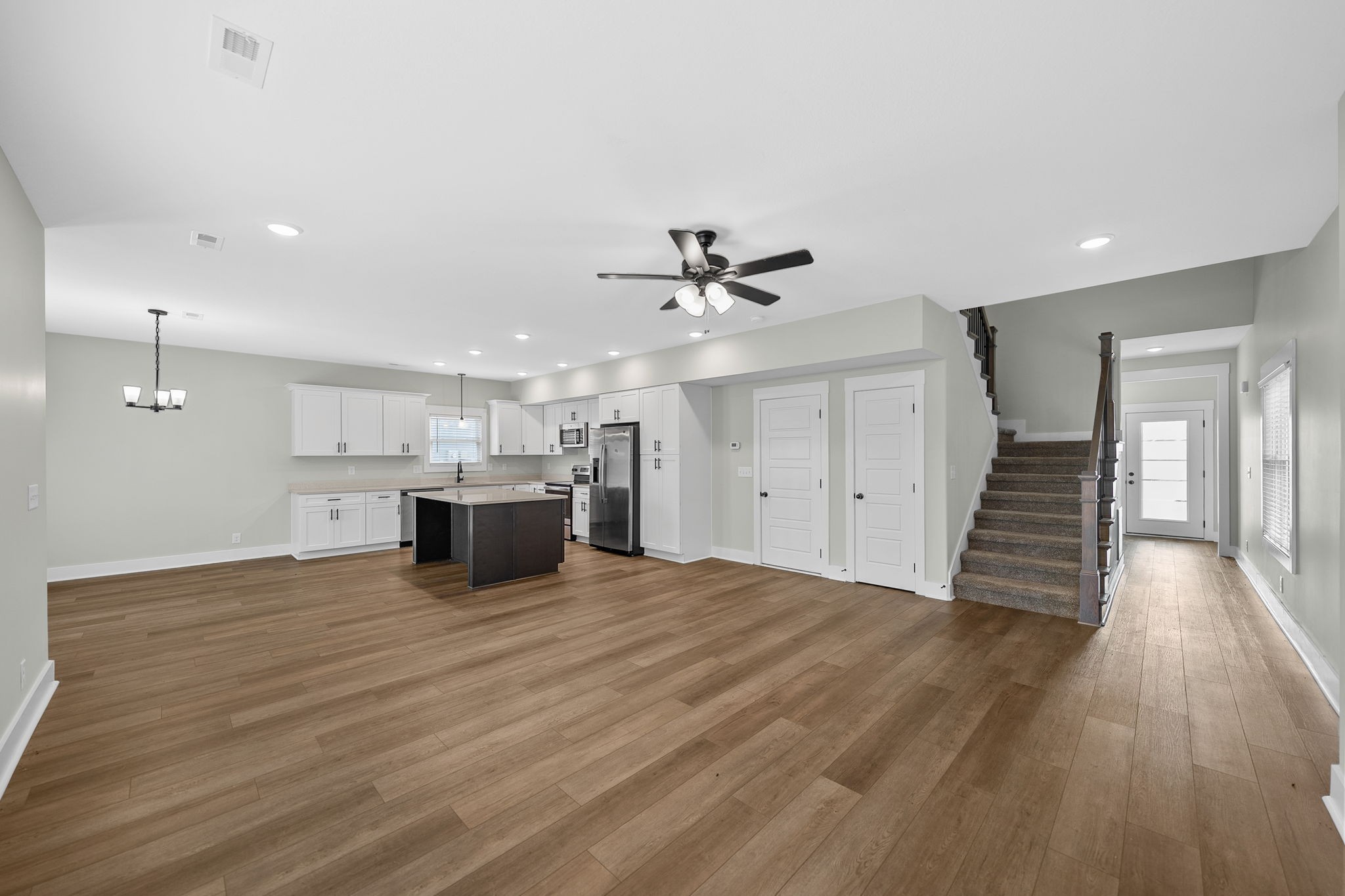 2509 Ashland City Road Clarksville, TN 37043 - Photo 8 of 32 a view of an empty room with wooden floor and a ceiling fan